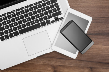 Responsive web designer desk with tablet, smartphone and open MacBook Pro