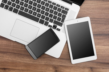 Responsive web designer desk with tablet, smartphone and open MacBook Pro - obrazy, fototapety, plakaty