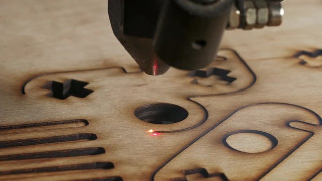 Laser cutting on wood. Slow motion.