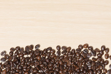Coffee beans on wood table with copyspace for text