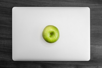 MacBook Pro on desk with apple - obrazy, fototapety, plakaty