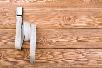 Trouser belt on the wooden background