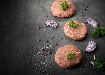 Raw burgers and ingredients