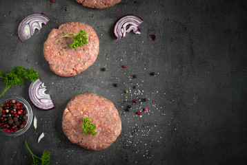 Raw burgers and ingredients