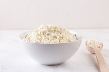 Fresh cottage cheese in a white bowl
