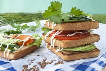 sandwiches with vegetables, fresh tomatoes, cucumbers and zucchini.