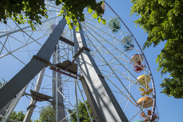 Retro Ferris Wheel on Blue cloudy Sky