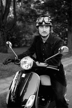 Handsome man looking away while sitting on bike (B&W)