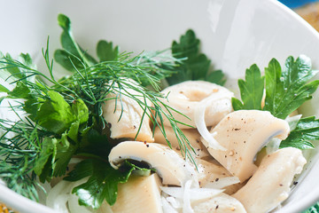 Salted milk mushrooms served in a white plate