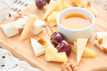 Healthy Breakfast from a set of cheeses Parmesan, mozzarella and Camembert on a wooden Board