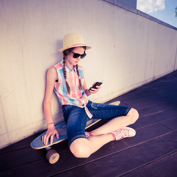 Hipster Girl Skateboarder listening to the music - Relax Lifestyle Concept -  toned with a retro vintage instagram filter