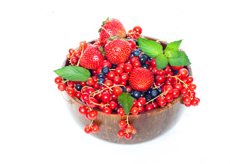 Different berries in wooden bowl