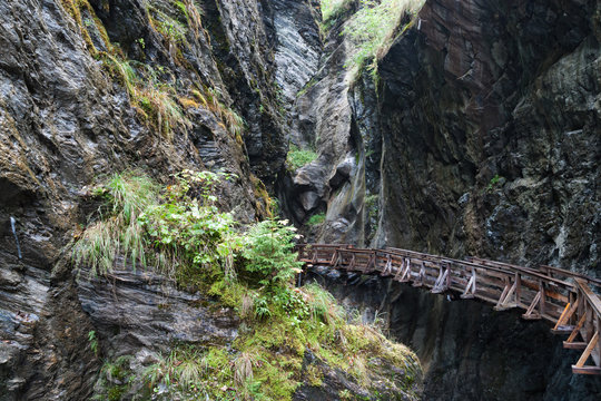 Wooden bridge in mountain canyon.