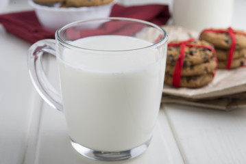 Very sweet retro bottle of milk with cookie on old table