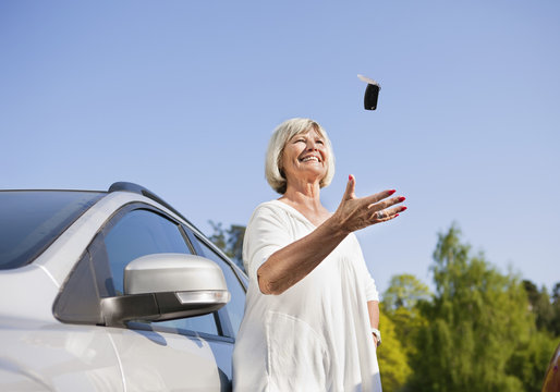 Senior woman throwing car keys