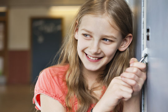 Happy girl with padlock in hand