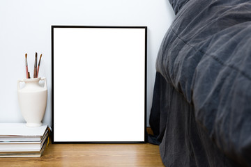 Empty blank classic black frame on a floor, minimal home bedroom