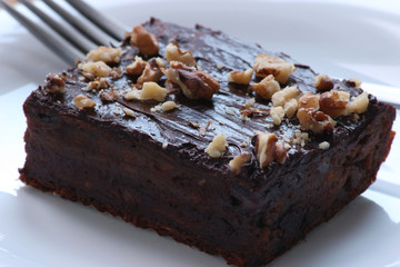 Delicious chocolate brownie. Close up of chocolate brownies. Delicious homemade chocolate cakes on top with walnuts. Shallow depth of field.