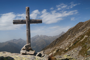 Wooden cross standing in italian Alps