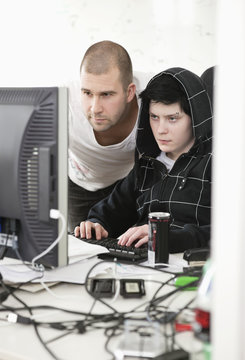 Two concentrated people by the computer