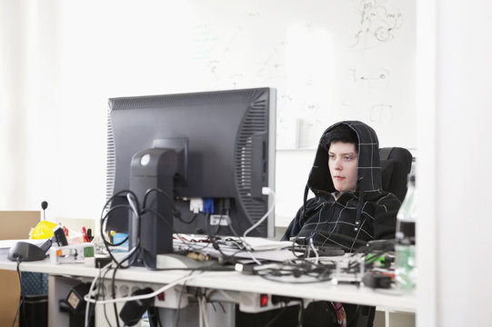 concentrated woman sitting by computer