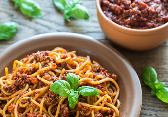Spaghetti with bolognese sauce on the wooden background