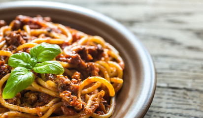 Spaghetti with bolognese sauce on the wooden background