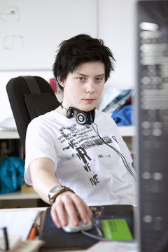 Woman leaning back by the computer