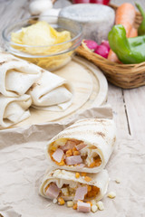 Breakfast burrito with eggs, cheddar, microgreens and roasted mu