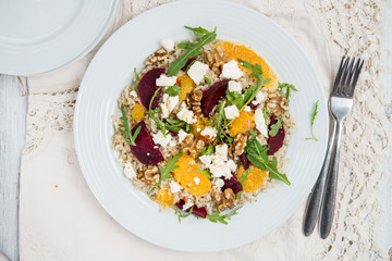 Warm Healthy quinoa, brown rice, cooked beetroot and orange sala