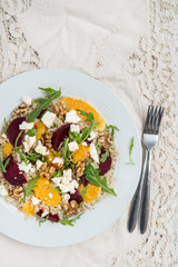 Warm Healthy quinoa, brown rice, cooked beetroot and orange sala