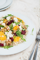 Warm Healthy quinoa, brown rice, cooked beetroot and orange sala