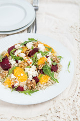 Warm Healthy quinoa, brown rice, cooked beetroot and orange sala