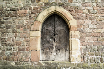 Fototapeta na wymiar Medieval Wooden Door in Stone Wall. Wissembourg, Alsace, France