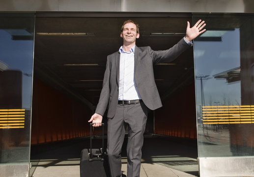 Happy man exits the airport