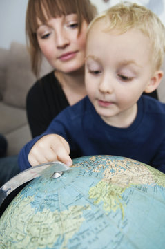 Mother and son looking at globe