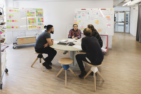 Engineers discussing on table in creative office