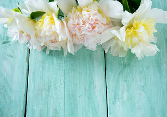 peonies on wooden surface