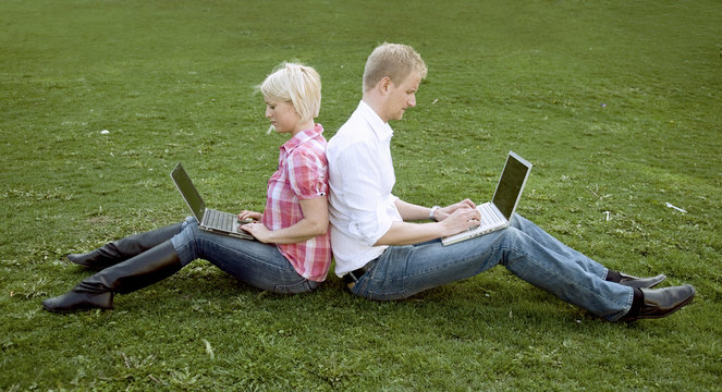 Girl and guy leaning against each other