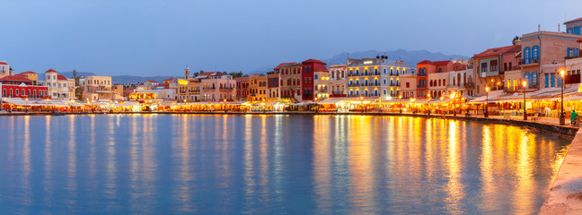 Picturesque panoramic view of old harbour and Venetian quay of Chania during twilight blue hour, Crete, Greece