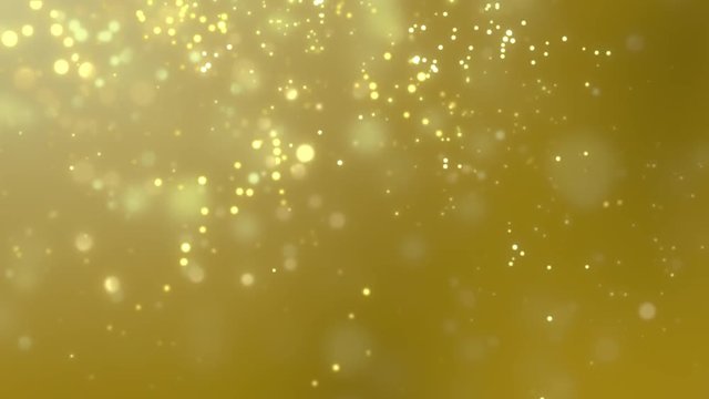 Blurred golden dust slowly falling against yellow background