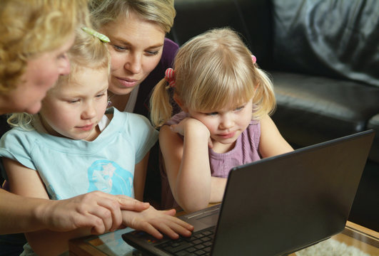 Family in front of computer