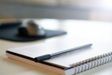 Pen and notepad on a desk