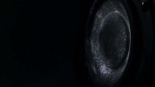 Dusty bass loud speaker in action. Super slow motion. Equalizer concept