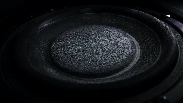Bass loud speaker throws dust in the air. Super slow motion. Equalizer concept