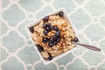 Oatmeal with chia seeds, brown sugar, blueberries, walnuts, and milk