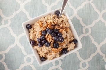 Oatmeal with chia seeds, brown sugar, blueberries, walnuts, and milk