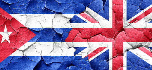 Cuba flag with Great Britain flag on a grunge cracked wall