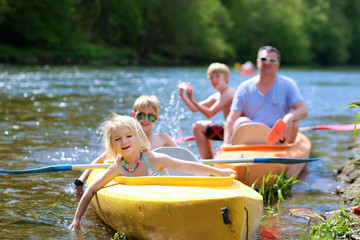 Family kayaking on the river. Active father with children, two teenage boys and little girl, having...