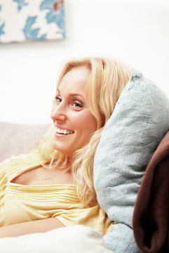 Harmonic woman lying in her couch at home